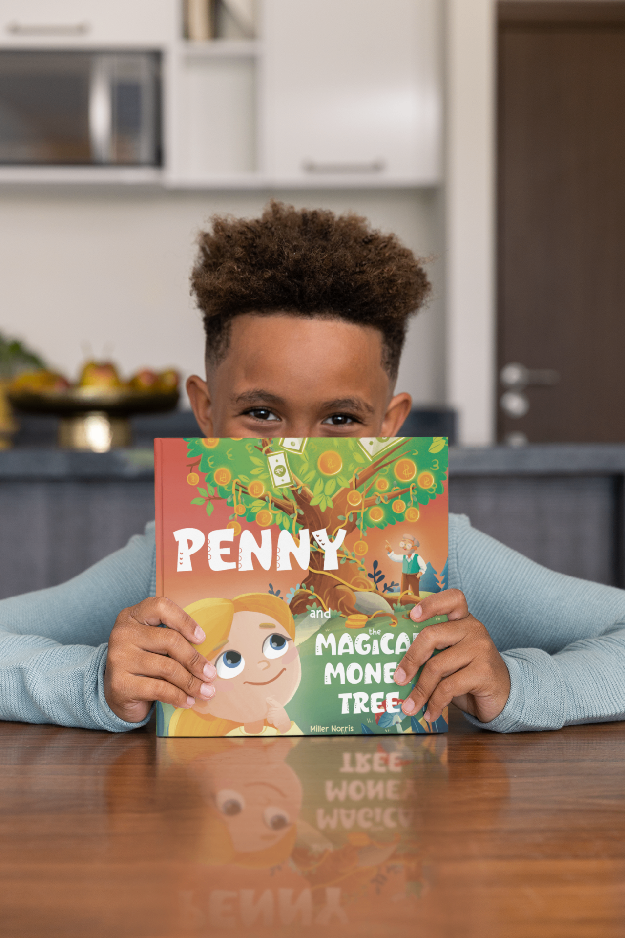 Boy peeking over the Penny and the Magical Money Tree book