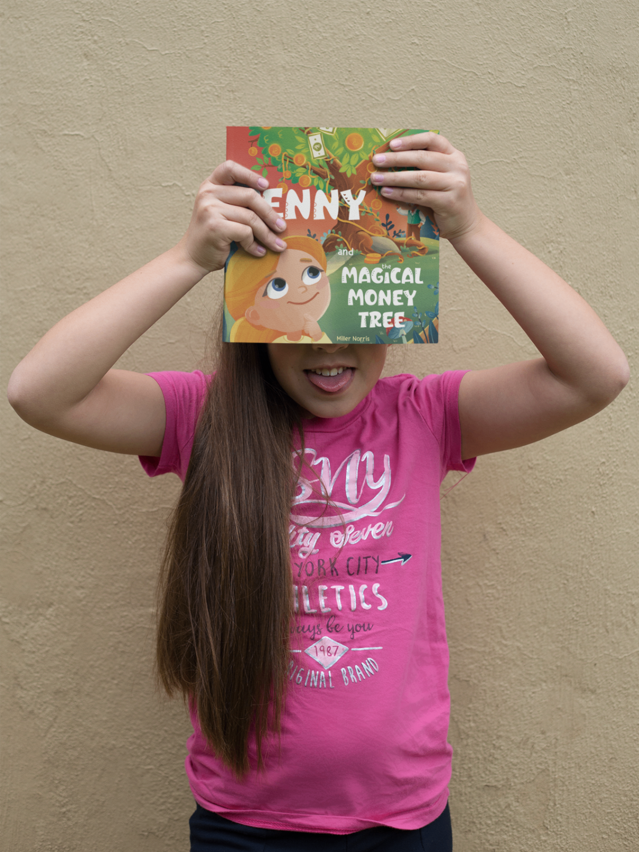 Girl playfully holding up the Penny book